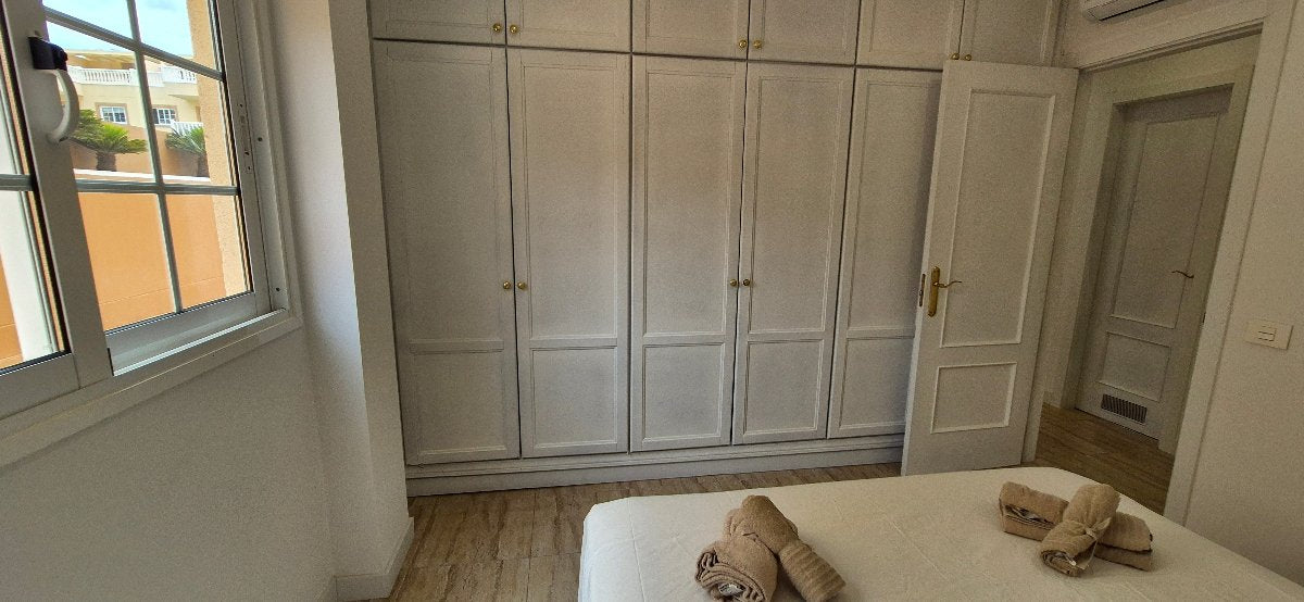 Palm Mar Unique Apartment Primavera Complex bedroom with queen-size bed and spacious wardrobe