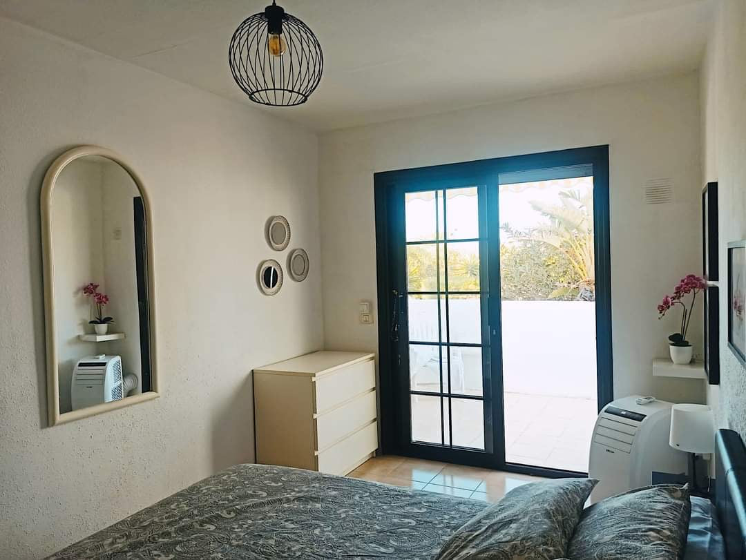 San Miguel de Abona Cozy House at Amarilla Golf spacious bedroom with queen-size bed and large window