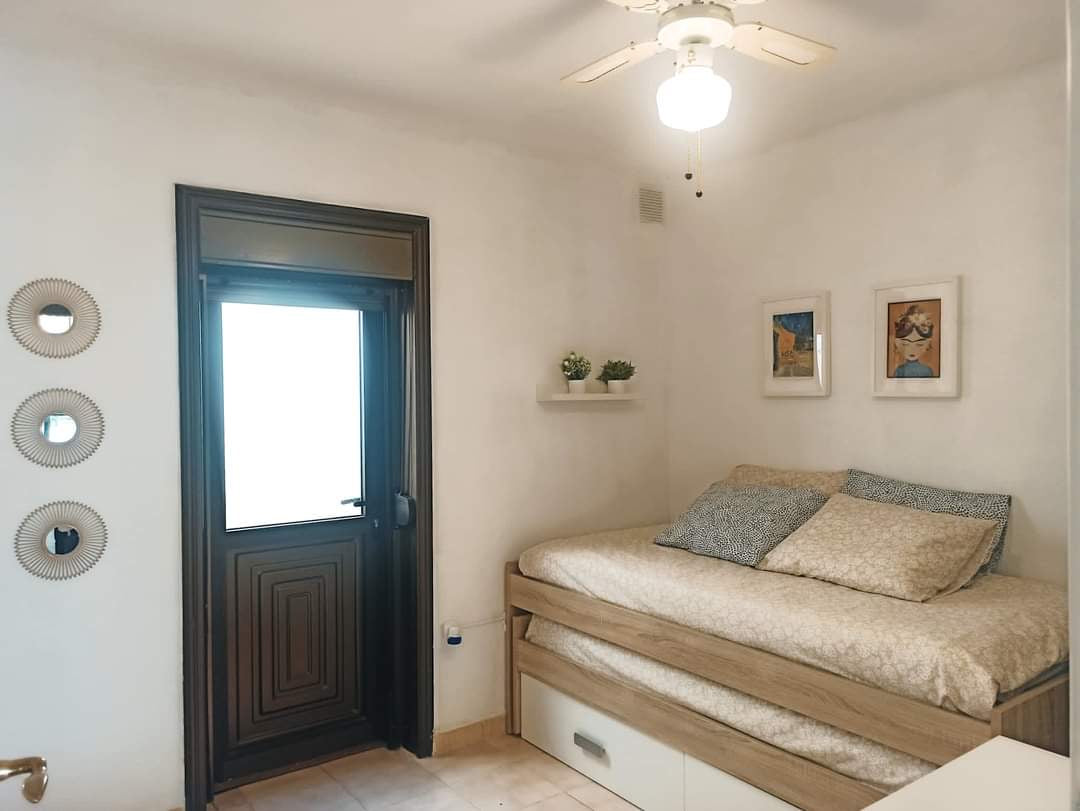 San Miguel de Abona Cozy House at Amarilla Golf spacious bedroom with queen-size bed and large window 2