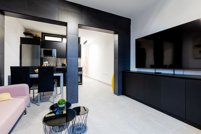 Spacious 2-Bedroom Apartment for Sale in Playa Paraíso Minimalist living room with comfortable seating and maxi flat screen tv